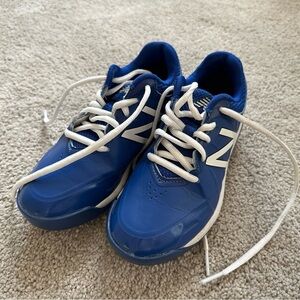 New Balance Blue and White football cleats.
